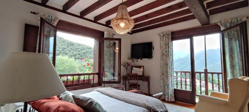 a bedroom with a bed and a large window at Posada El Bosque in Mieses
