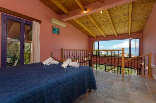 a bedroom with a bed and a balcony at ELIA VILLA 1 in Alikanas