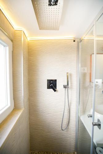 a shower in a bathroom with a glass door at Lucy's House in Riomaggiore