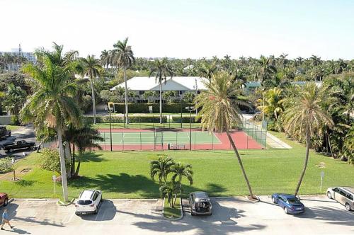 a parking lot with a tennis court and palm trees at Berkshire by the Sea in Delray Beach
