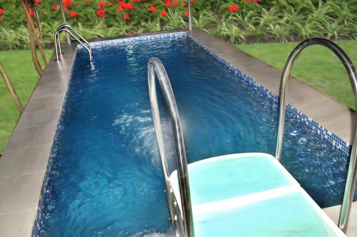 a plunge pool with a chair in a yard at J Gibson Hotel in Lagos