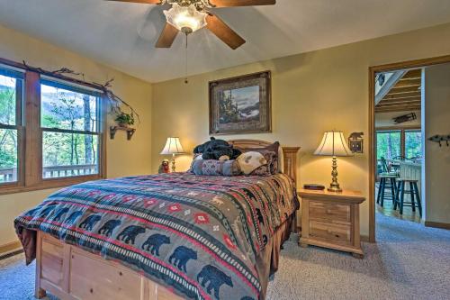 a bedroom with a bed and a ceiling fan at Spacious Maggie Valley Cabin with Hot Tub and MTN View in Maggie Valley