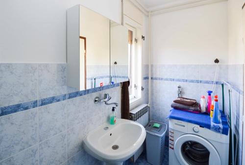 a bathroom with a sink and a washing machine at Apartment in Banjole/Istrien 17372 in Banjole