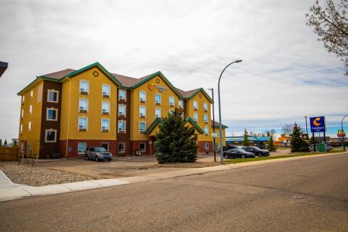 a large yellow building on the side of a street at Comfort Inn in Lethbridge