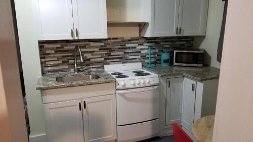 a kitchen with a white stove and a sink at Relaxing, Comfortable, Private Bedroom in Atlanta