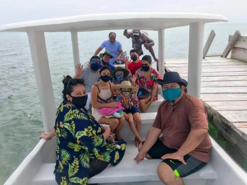 a group of people in a boat wearing masks at Tropical Paradise in Caye Caulker