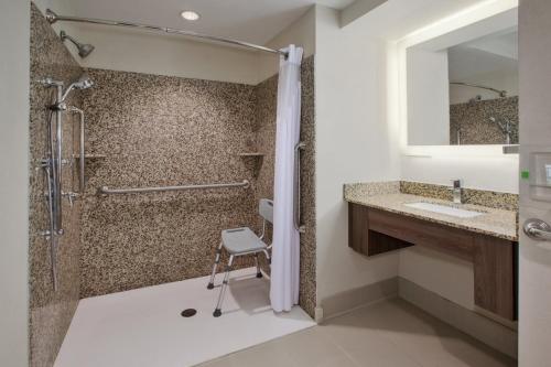 a bathroom with a shower and a sink at Holiday Inn Morgantown-University Area, an IHG Hotel in Morgantown