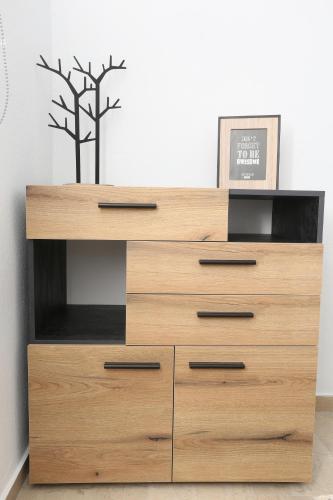 a large wooden dresser in a room at Mare Monte Luxury Apartments 2 in Nea Skioni