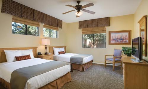a bedroom with two beds and a ceiling fan at Club Wyndham Sedona in Sedona