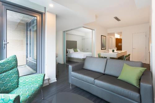 a living room with a couch and a bedroom at reStays Ottawa in Ottawa