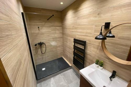 a bathroom with a tub and a sink and a shower at Très beau appartement au centre historique de Riez in Riez