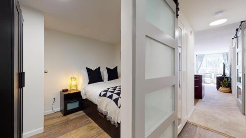 a bedroom with a bed and a sliding glass door at Beautiful Marketplace Condo with Mountain Views in Whistler