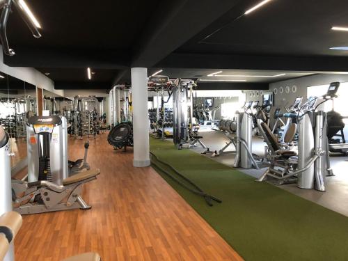 a gym with lots of treadmills and machines at Oceanview Apartment in San José del Cabo