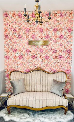 a couch in a room with a flower wall at Monopoly Holiday Home in Blackpool