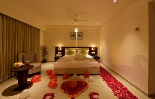 a bedroom with a bed with a red heart on the floor at HOTEL CYPRESS in Nadiad
