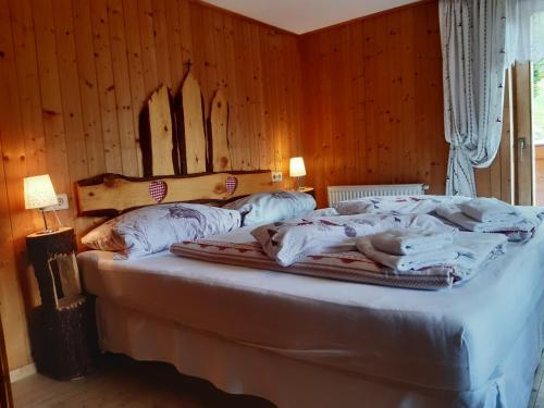 a bedroom with a bed with a dog laying on it at Bed & Breakfast Dolomiti Bey Haus Pinter in Assling