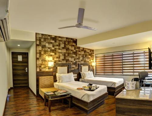 Säng eller sängar i ett rum på Hotel Aaram Orchard