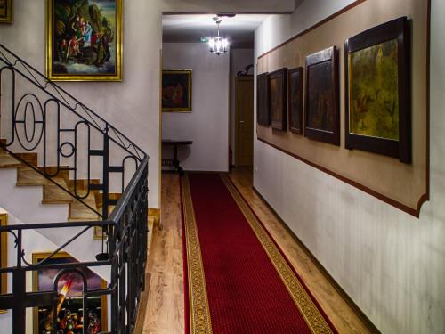 a hallway with a staircase with a red carpet at Hotel Puntijar in Zagreb