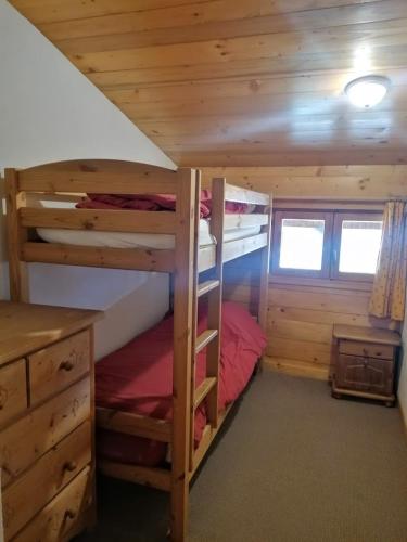 a bedroom with two bunk beds in a cabin at Résidence Chalet des Granges in Samoëns
