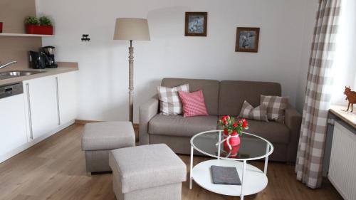 a living room with a couch and a table at Ferienwohnungen im Färberhaus in Fischen