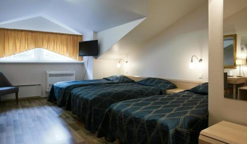 a hotel room with two beds and a window at Fra Mare Thalasso Spa in Haapsalu