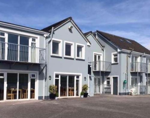 a large white house with a lot of windows at Dingle Harbour Nights - Room Only in Dingle