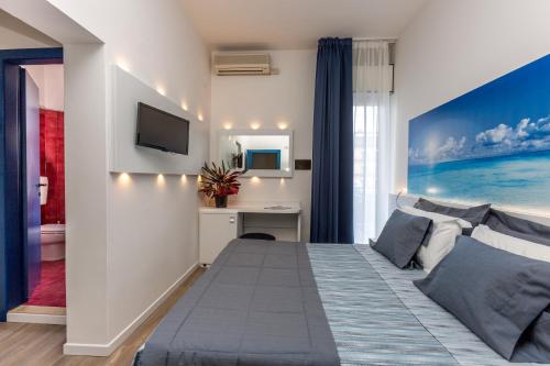 a bedroom with a bed and a desk in a room at Hotel Wally in Lido di Jesolo