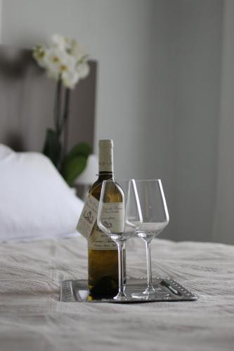 a bottle of wine and two wine glasses on a table at Hotel Regina Margherita in Bordighera