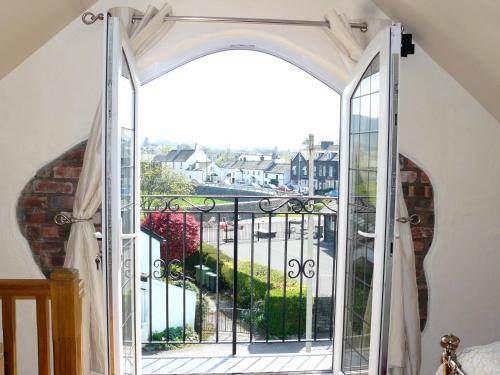 an open door to a balcony with a view at Riverside Escape in Keswick
