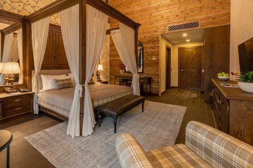 a bedroom with a bed with a canopy at Bengodi Boutique Hotel in Eceabat