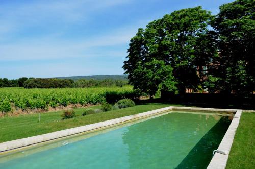 - une piscine dans une cour à côté d'un champ dans l'établissement Le Mas Perréal, à Saint-Saturnin-lès-Apt