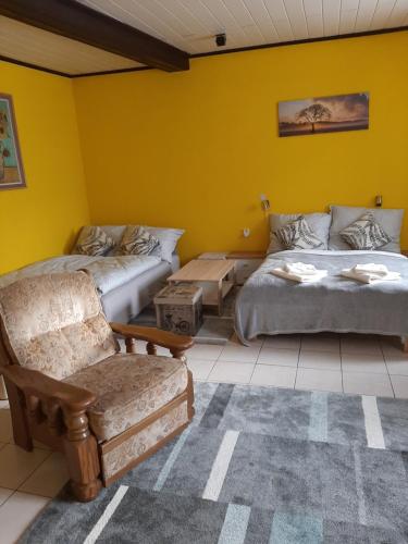 a living room with two beds and a couch at Apartmán u Junků in Pernink