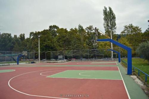 a court with a basketball hoop on a tennis court at Suite Acropolis Serres With Parking Next to Center in Serres