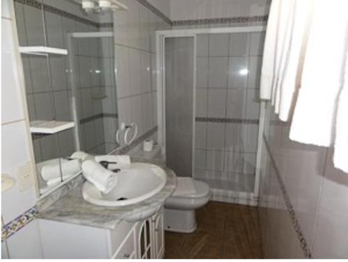 a white bathroom with a sink and a toilet at Finca Gerardo Miraflor in La Playa Calera
