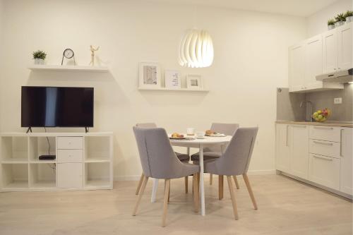 a kitchen with a table with chairs and a tv at Anastasia Apartments & Rooms - Zagreb Centre in Zagreb