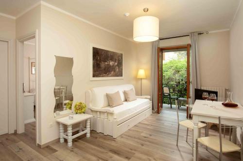 a living room with a white couch and a table at Valle Del Buttero in Capalbio
