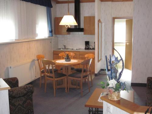 a kitchen and dining room with a table and chairs at Gasthof Rodachtal mit Gästehaus Katharina in Schwarzenbach am Wald