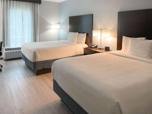 a hotel room with two beds and a window at Comfort Inn & Suites Melbourne-Viera in Melbourne
