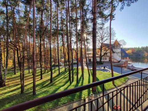 a view of a house from a balcony with trees at Заміський комплекс "Пуща Лісна" in Moshchun