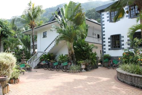 a building with bikes parked in front of it at Hotel Chateau St Cloud in La Digue