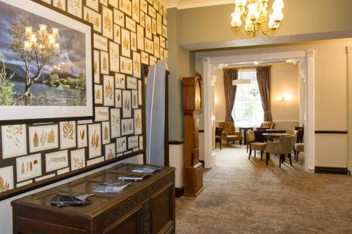 a living room with a large wall of pictures at Royal Victoria Hotel Snowdonia in Llanberis