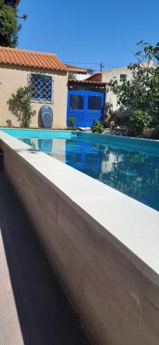 a swimming pool in front of a house at Quinta D'Avó Amélia in Alquerubim