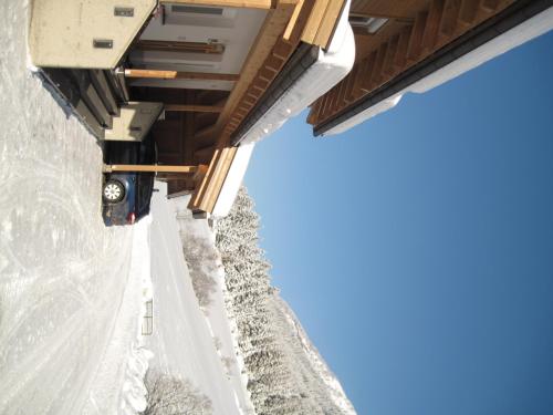 a view from underneath a building in the snow at Alpina Appartement in Sankt Leonhard im Pitztal