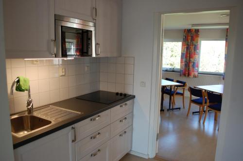 a kitchen with a sink and a counter top at Allégården Kastlösa Hotell in Kastlösa