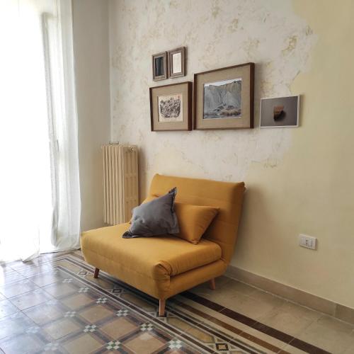 a couch in a living room with a pillow on it at Noù la tua casa in Puglia in Alberobello