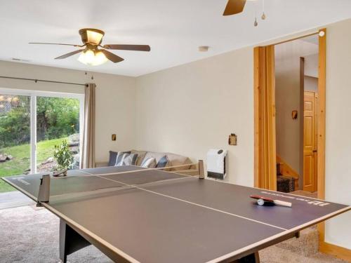 a living room with a ping pong table at Soco Serene Cabin in the Heart of Maggie Valley in Maggie Valley