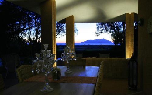 a dining table with a view of a mountain at Dimora dell'Olivastro in Favignana