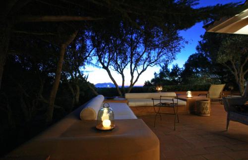 a patio with a table with candles on it at night at Dimora dell'Olivastro in Favignana
