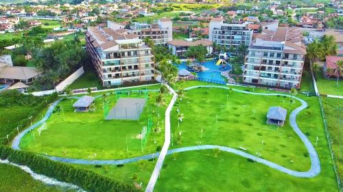 
a green field with lots of green grass and trees at Beach Living Apartments by BomgoBrasil in Aquiraz
