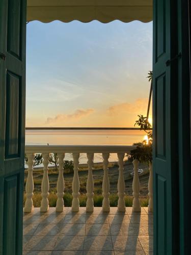 an open door to a balcony with a view of the ocean at Xenia Apartment in Kokkari